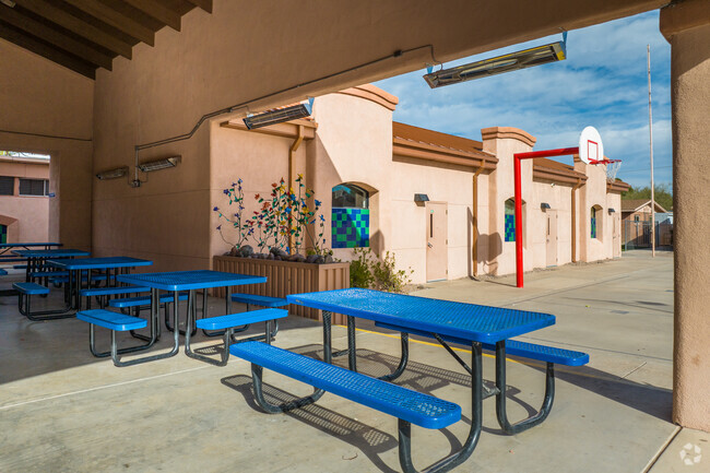 Students at Presidio School an enjoy lunch outside on a shaded playground next to the playground