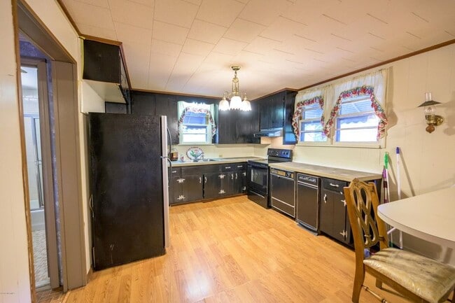 Kitchen has new fridge, dishwasher and lots of cabinets.