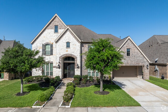 Arched entryways and brick exteriors are common traits among houses in Southern Trails.
