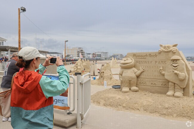 Spectators enjoy the Hampton Beach Sand Sculpting Classic.