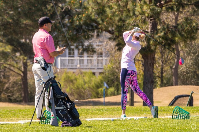 Charleston National driving range is loaded with neighbors on a nice day.
