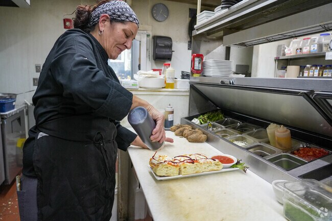 The head chef at 308 Lakeside in East Brookfield drizzles balsamic on the focaccia.