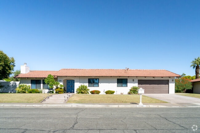 This spacious one-story home, with a spacious front lawn, is one of many inside Oasis del Sol.