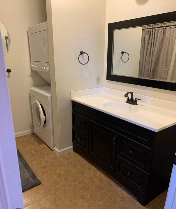 Tub/Shower and clean modern bathroom. Tile floor-washer and dryer included.