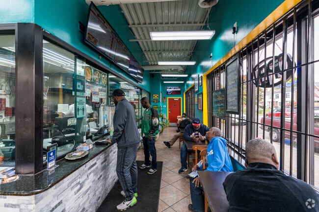 Neighbors enjoy Caribbean food during a busy lunch hour in Evergreen-Outer Drive, Detroit.