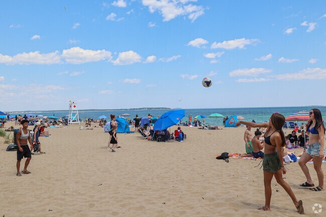 Enjoy a game of volley ball on the beach with friend near Kinney Shores.