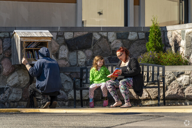 Parkside residents read a book from one of the Little Libraries near Parkside.