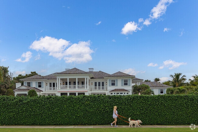 A leisurely dog walk past a beautiful home epitomizes the South End lifestyle.