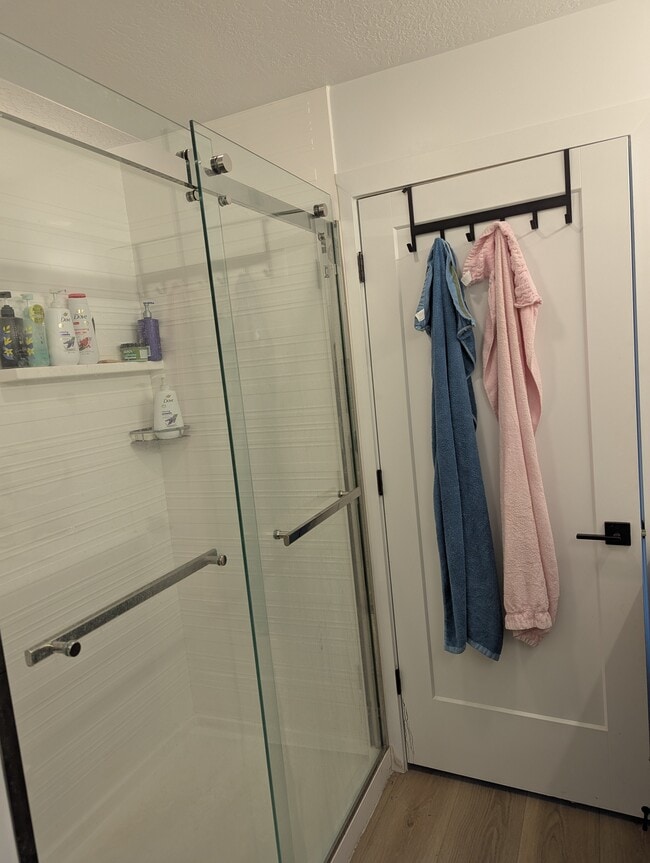 ensuite bathroom featuring a shower stall