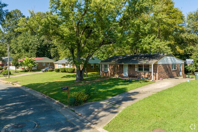Brick ranch homes in Summit Hills sit beneath mature trees.