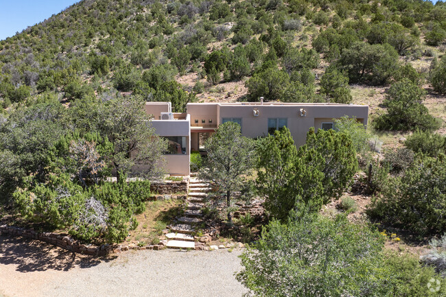 Santa Fe style homes hidden by trees for maximum privacy in Old Las Vegas Corridor.