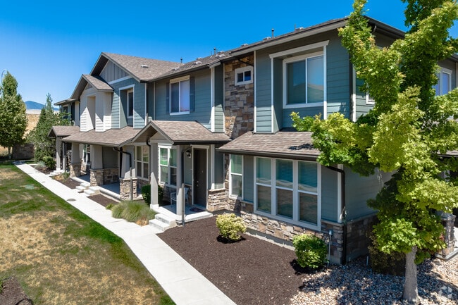 Duck egg blue townhomes with stone detail at San Tropez in the South Jordan neighborhood.