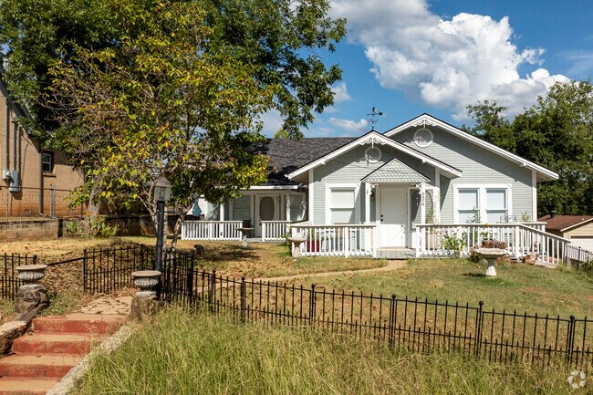 A beautifully maintained cottage sits on a hill in Midtown Tyler.