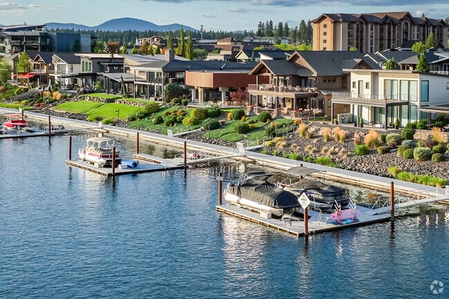 Rows of riverfront properties with private docks line the north shore of the Spokane River.