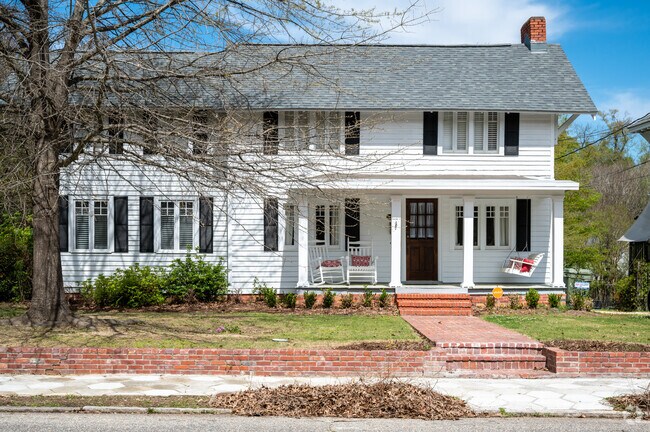 Sit and chill on this amazing front porch in Great McGehee Estates..