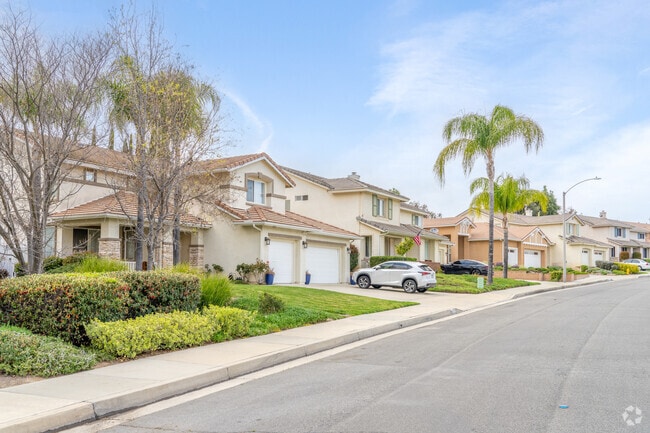 A sleek row of two-story modern homes in Serena Hills showcases clean lines, open spaces, and contemporary designs, offering a stylish and vibrant living experience.