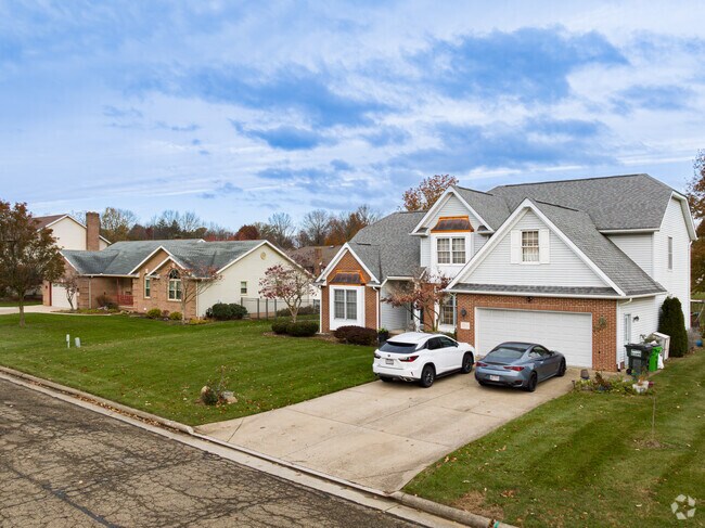 Two late 20th century homes with brick facades and large yards in Sippo Heights.