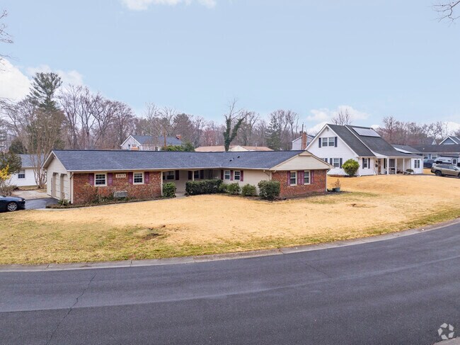 A mid-century brick ranch home adjacent to a Cape Cod in Idlewild.