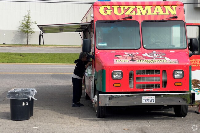 A Woman Orders Tacos at Dos Hermanos Taco Truck.