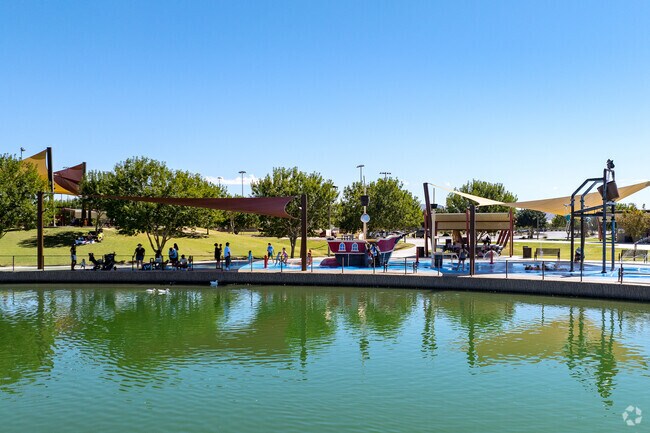 Kids cool off and parents can get out of the sun at the splash pad in Mansel Carter Oasis Park.