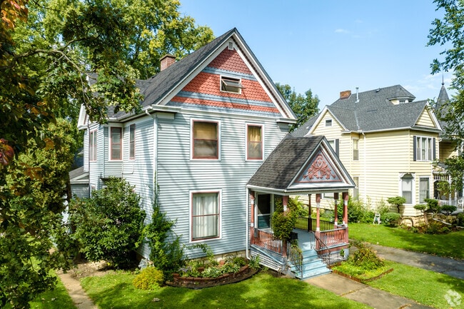 Victorian style home with colorful facade and entrance porch located in downtown Aurora.