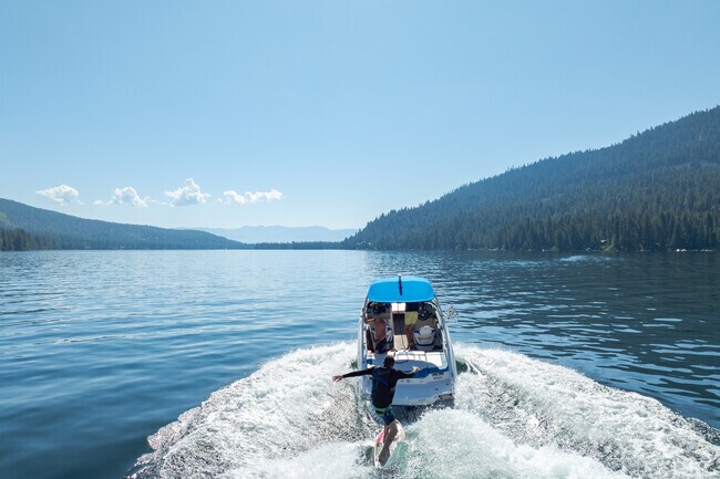 Summer wake surfing highlights lake recreation near Truckee in the Sierra Nevada.