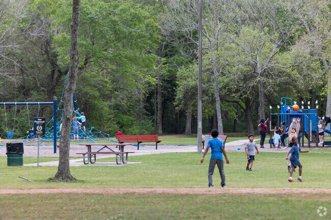Children play on the playground equipment at Christia V. Adair Park's play area.