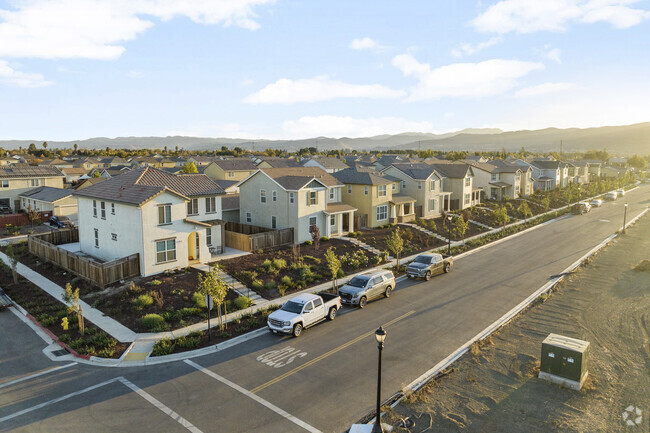 A row of newly built homes reflect the sun in King City, California.