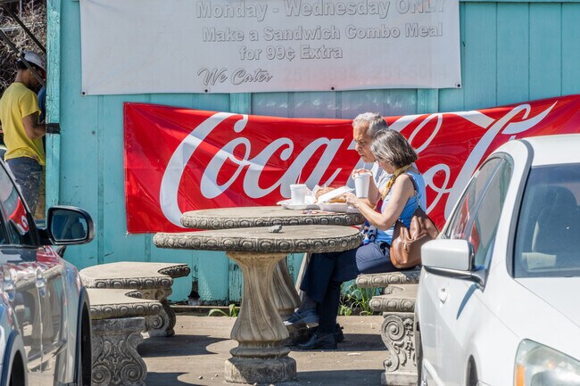 A couple enjoying food outside of River Fish Market.