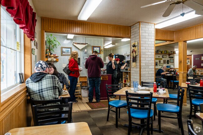 The Server works quickly in the busy Poppa's Place in Brooklyn.
