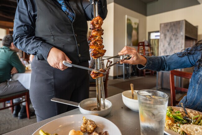 Em Chamas Brazilian Grill is known for Rodizio table-side service in Parkdale-Walden.