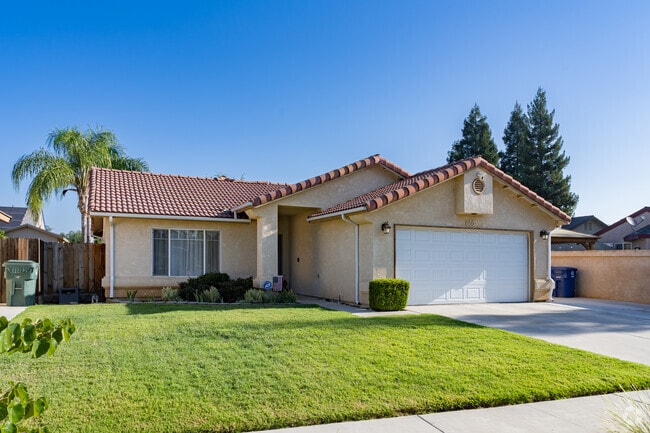 A Spanish style inspired home with well maintained lawn in Farmersville.