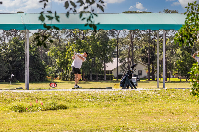 A golfer practices his swing at one of the courses near the High Point neighborhood.