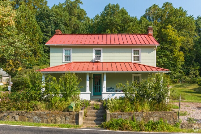 This Prairie home has a modern red metal roof and expansive land in Lower Frederick Township.