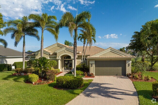 Single-family homes with tile roofs are scattered amongst the neighborhood on golf courses