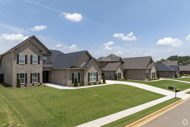 The new construction homes have sidewalks and large front yards.