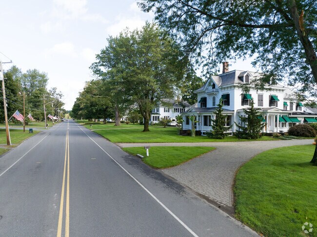 Flags flying and historic homes on Elm St in Hatfield, MA.