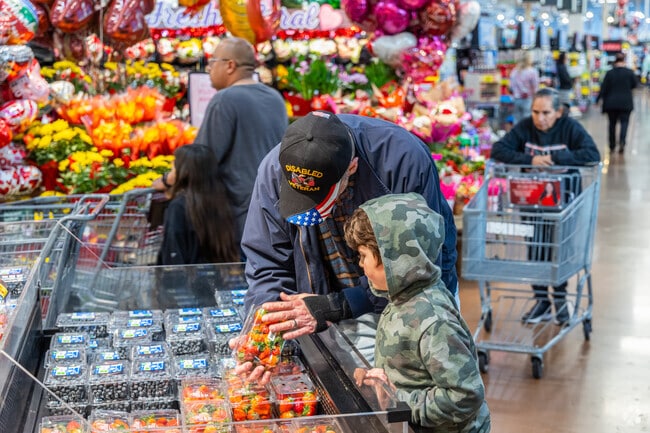 Grandfather and grandson pick fresh strawberries at Fry's Food in North Mountain Village.