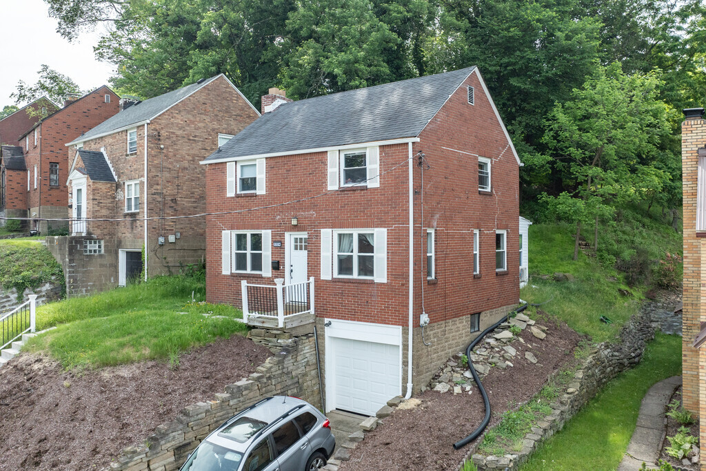 Some single family houses sit tall up on steep hills on the edge of Laketon.