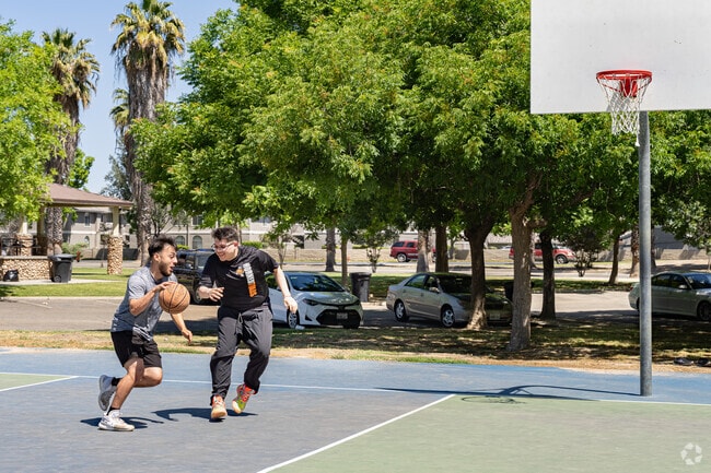 Two friends play a quick game of basketball at Heritage Park in Lemoore.