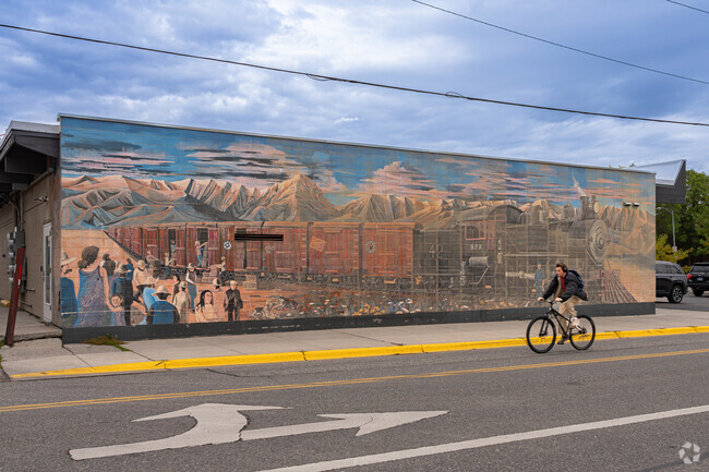 A large historical mural is featured along a main road through Bogert Park.