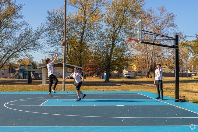 Local teenagers play basketball on the nice courts at Indian Creek Park.