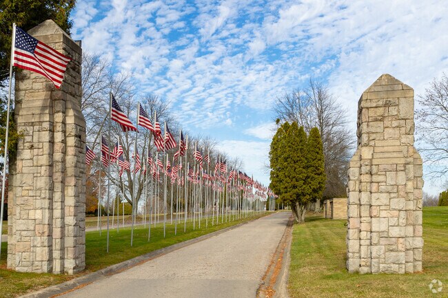 A row of flags and a vibrant blue sky is the entrance to Hillcrest Memorial Park in Hermitage.