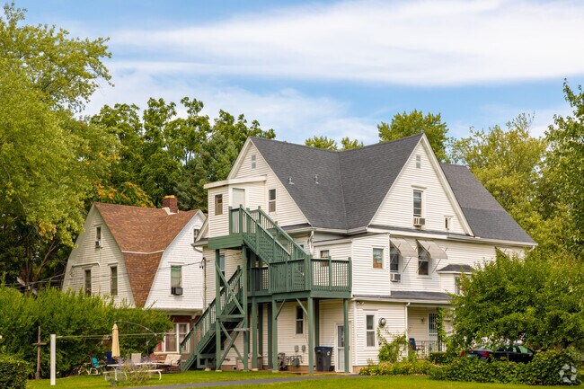 A row of multi-unit homes featuring a green staircase in Zion, IL.