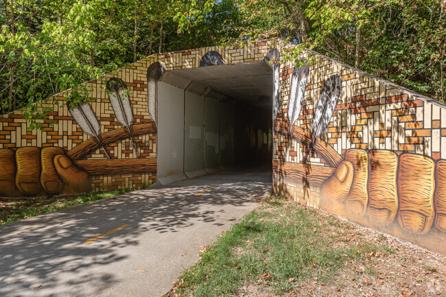 A cultural mural is depicted on a tunnel in Downtown Fayetteville.