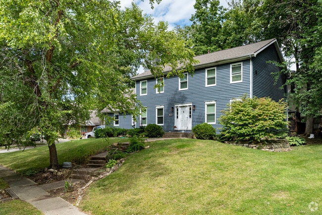 Colonial Revival homes embrace the lush landscape of Irvin Park and maintain large lawns.