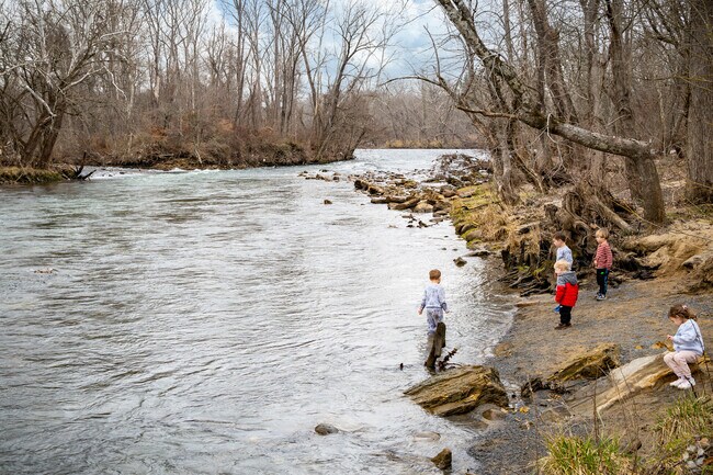 A ground of young children explore the rivers edge at Sycamore Shoals State Historic Park.