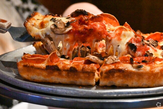Grab a slice of cheesy deep-dish pizza at Rogala's Bar and Grill in Garden City.