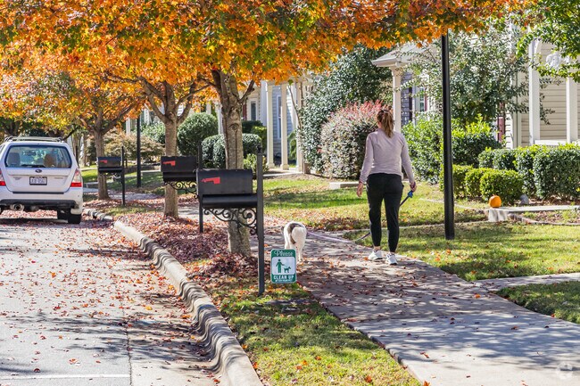 In Salem Woods, tree-lined sidewalks provide shade for local dog walkers as they stroll along.