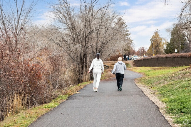 Two women enjoy a walk around Kaysville Ponds in West Kaysville.